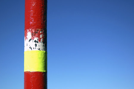 Image of a marker indicative of danger, red and yellow 