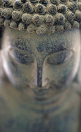 Image of the face in an ancient statue of Buddhaの写真素材