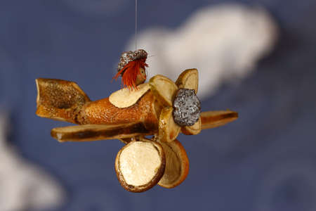 Orange made airplane against blue skyの写真素材