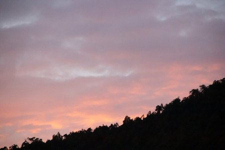 Dramatic sunset with soft clouds in orange, pink and blue tonesの写真素材