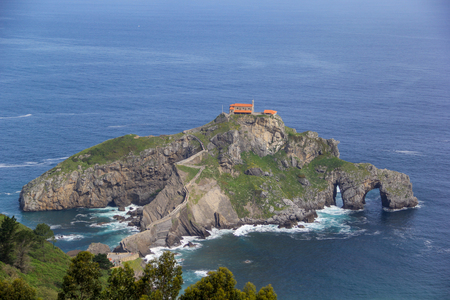 Island connected to land through an impresive stone pathの写真素材