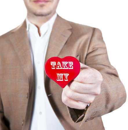 Man in brown jacket offering a red heart with the words  take my  の写真素材