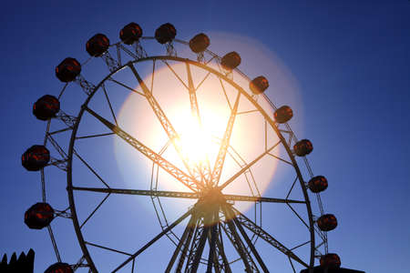 Summer day in circus, ferris wheel, sun flareの写真素材