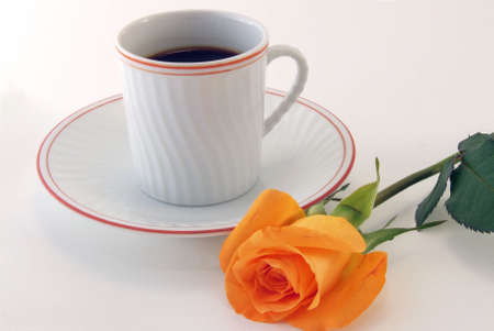 A cup of hot coffee with a rose as decorationの写真素材