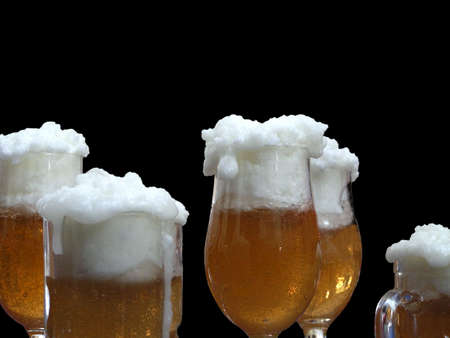 Blonde beer glasses against a black backgroundの写真素材