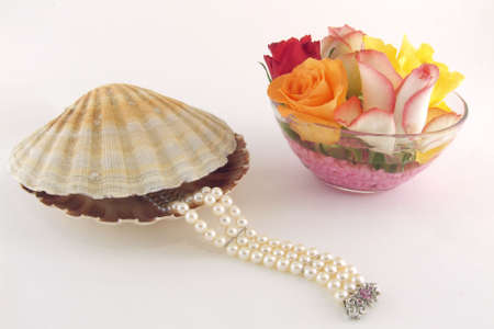 A pearls bracelet going out from a shell and flowers as decorationの写真素材