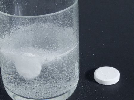 Aspirin in a water glass to take care of health