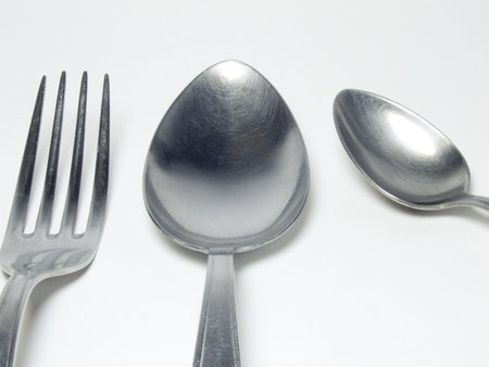 Fork and spoons in the kitchen on a white background
