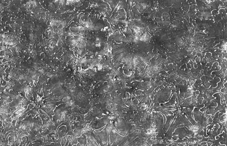 Monochrome abstract grunge background. Gray rough texture with scratches, dots and lines, with contours of colors. Tone transitions, white contours of daisies, daisies and algae. Hand drawing.の写真素材
