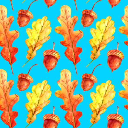 Seamless pattern with oak leaves and acorns. Watercolor autumn leaves fallen orange and yellow with colorful drops and sprays on a sky-blue background. Template for design.の写真素材