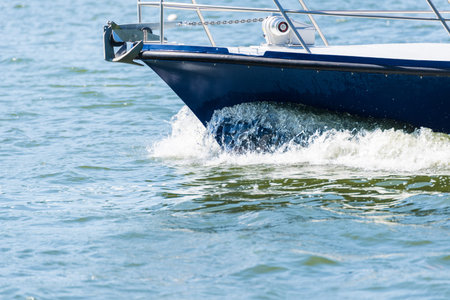 Berlin, Berlin/Germany - 07.23.2018: The bow of a motorboat at full speed with bow wave on a lake in...