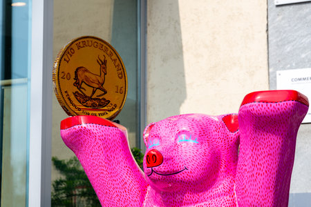 Berlin, Berlin/Germany - 23.03.2019: A Krugerrand coin on a Budddy bear in pink in front of the Commerzbank Berlin branch at Theodor-Heuss-Platzのeditorial素材