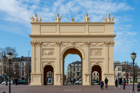 Potsdam, Brandenburg/Germany - 24.03.2019: The Brandenburg Gate in Posdam on a sunny day with some clouds. You see a street sceneのeditorial素材