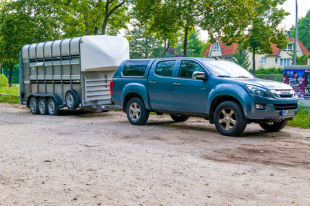 Berlin, Berlin/Germany - 06.08.2019: A horse trailer with three axles and an off-road vehicle...