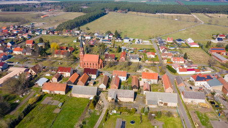 Paaren am Glien, Brandenburg/Germany - 26.03,2020: The village Paaren Glien in Brandenburg photographed from the air with the village church in the middle and individual farmsのeditorial素材