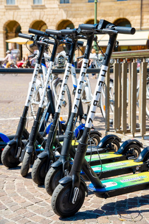 Verona, Veneto / Italy - 08/18/2020: Several e-scooters for rent in Verona so that tourists and visitors can cover distances on the e-scooter and do not have to walk.のeditorial素材