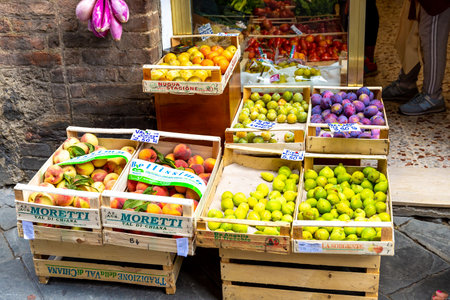 Florence, Toscana-Italy - 08/24/2020: A store with various fruits and vegetables in Italy in front of the shop window in wooden boxes.のeditorial素材