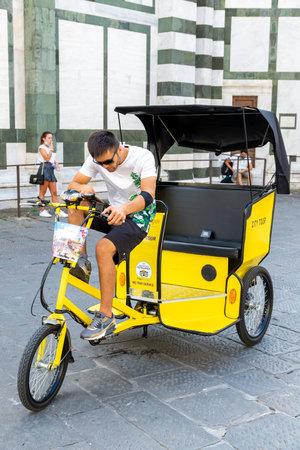 Florence, Toscana / Italy - 08/24/2020: A bicycle cab with driver in Florence waiting for passengers or touristsのeditorial素材