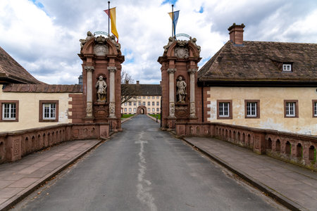 HÃ¶xter, Nordrhein-Westfalen-Germany - 04-04-2021: The entrance to Corvey Castle in HÃ¶xter in Germany via a bridge through a portal. In the foreground you can see relatively inconspicuous buildings and you can see that the site is very large.のeditorial素材