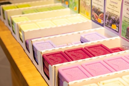 HÃ¶xter, Nordrhein-Westfalen-Germany - 04-04-2021: HÃ¶xter, Nordrhein-Westfalen-Germany - 04-04-2021: Different kinds of sheep milk soap in different colors in the original sales boxes on a wooden tableのeditorial素材