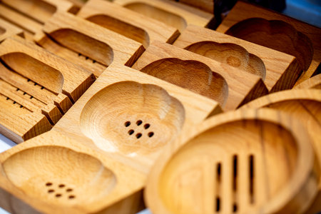 Various wooden soap dishes with drain holes and in different shapesの写真素材