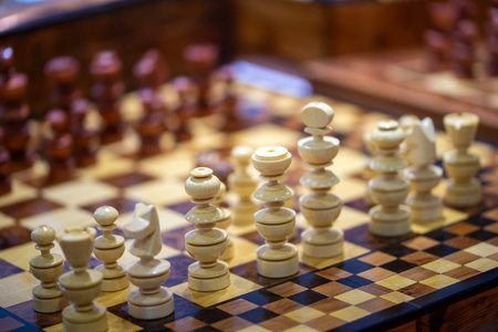 A beautiful chess game with white pieces in the foreground with pleasant light