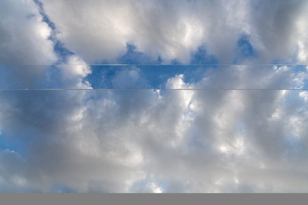 Light and dark clouds against a blue sky.