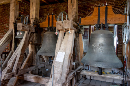 Rerik, Mecklenburg-Western Pomerania - Germany - 06/11/2023: Bell installation of the Parish Church in Rerik. Wooden frame with Latin inscriptions and manufacturer details.のeditorial素材