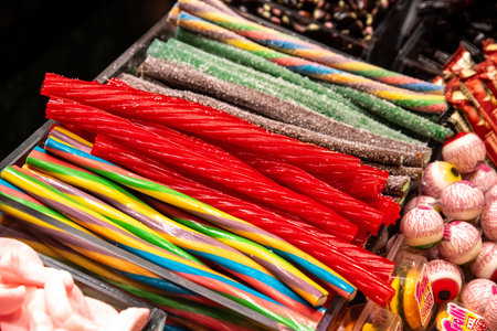 Sweets in the form of long sticks in bright colors, with imitation sugar eyes, sorted and ready for...