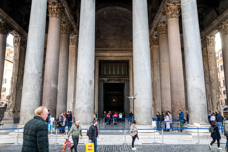 Roma, Lazio - Italy - 11-21-2022: Visitors at the grand entrance of Rome's Pantheon, flanked by...