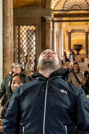 CittÃ  del Vaticano, Vaticano - Stato della CittÃ  del Vaticano - 11-22-2022: A man marvels at the magnificent architecture within the Vatican Museums, surrounded by historyのeditorial素材