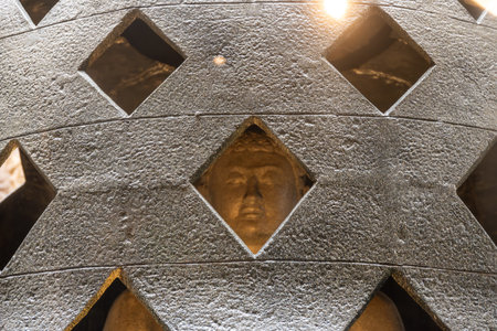 CittÃ  del Vaticano, Vaticano - Stato della CittÃ  del Vaticano - 11-22-2022: Close-up of a textured bell sculpture with Buddha's head, an amalgamation of different cultural art formsのeditorial素材