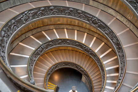 CittÃ  del Vaticano, Vaticano - Stato della CittÃ  del Vaticano - 11-22-2022: An exquisite spiral staircase with detailed ornamentation winds elegantly inside the Vatican Museumsのeditorial素材