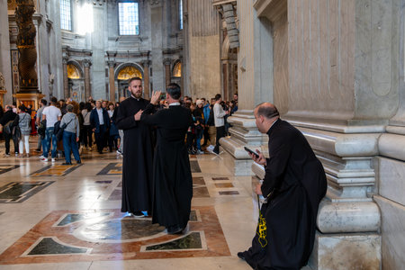 CittÃ  del Vaticano, Vaticano - Stato della CittÃ  del Vaticano - 11-22-2022: Priests document their visit to St. Peter's Basilica, capturing the architectural grandeur and bustling atmosphere within this iconic landmarkのeditorial素材