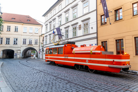 Prague, Capital City of Prague - Czech Republic - 09-20-2022: Historic orange tram on the quaint streets of Prague, near a local hotelのeditorial素材