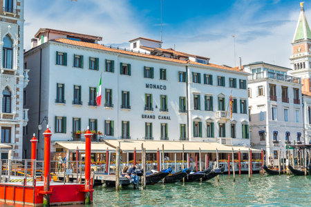 Venice, Veneto - Italy - 06-10-2021: Hotel Monaco fronting Grand Canal, adorned with Italian flags and gondolasのeditorial素材