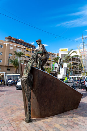 Puerto de Mazarron, Murcia - Spain - 01-18-2024: Bronze statue of a fisherman repairing nets, symbolizing Puerto de Mazarron's heritageのeditorial素材