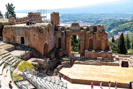 Ruins and arches of ancient theatre in Taorminaの写真素材