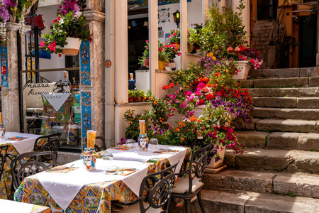 Flowered Restaurant Scene with Stairs in Taorminaの写真素材
