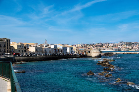 Syracuse coastline with historic buildings and blue waterの写真素材