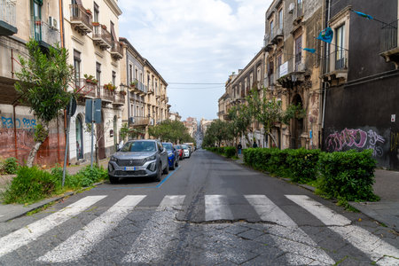 Urban Street with Parked Cars and Old Buildingsの写真素材