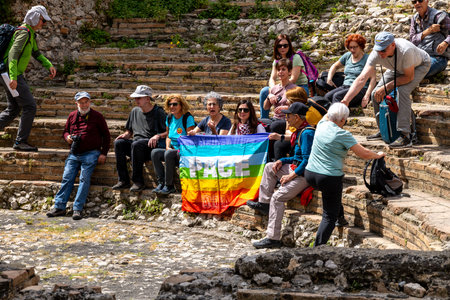Tourists with Peace Flag at Odeon in Taorminaの写真素材