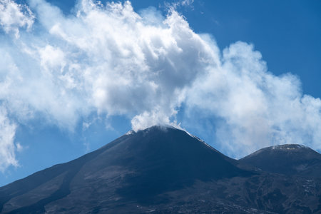 Volcanic summit with smoke cloud on Mount Etnaの写真素材