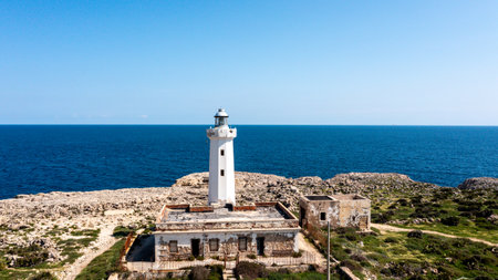 Close-up of weathered lighthouse facing the open seaの写真素材