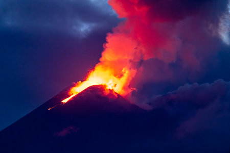 Mount Etna erupting under twilight skyの写真素材