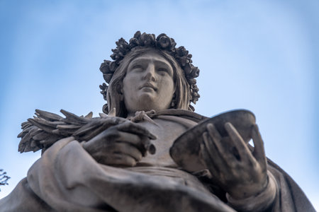 Close-up of stone statue with floral crownの写真素材