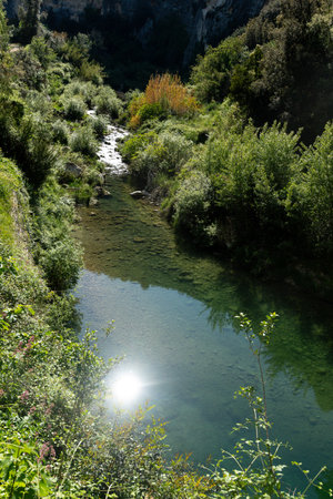 Clear stream reflecting sunlight in Pantalica valleyの写真素材
