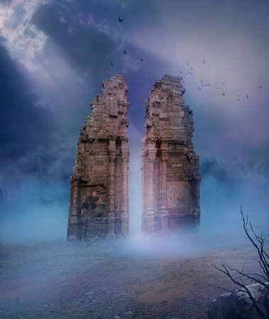 view of ruins of old temple in a desert illuminated with a ray of lightの写真素材