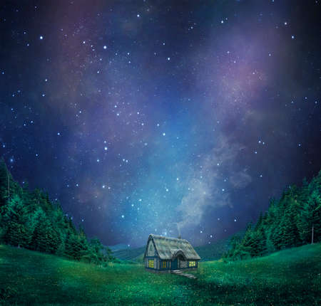 a cottage in the mountains with a fantastic sky at nightの写真素材