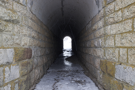 Tunnel under the railway on a winter day with a long exposureの写真素材